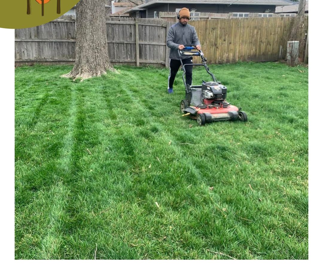 A Jesus Seed crew member mowing clean stripes into a green backyard